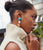 Model in profile wears cream knit sleeveless turtleneck with Enchanted Heart Earrings.