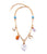 Moonlight Charm Necklace. Gold-plated long-link chain with assorted gold, amazonite, resin, and mother-of-pearl charms.