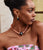 Model in strapless floral top wears Peach Blossom Necklace and Organic Hoops in Marine.