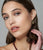 Model in close-up on grey backdrop wears 14k Pastille Earrings in Lemon Quartz.