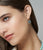 Model in close-up on grey backdrop wears King Earrings in Sky Blue Topaz and Citrine.