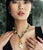Model with hands on chest wears black sleeveless top with Geneva Necklace and Pablo Earrings in Green.