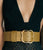 Close-up on model's waist, she wears low-cut black top and textured skirt cinched with Florence Belt in Khaki.