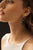 Model's profile on black backdrop; she wears cream tank and Ceremony Earrings in Onyx.