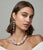 Model on grey backdrop wears Mykonos Earrings in Strawberry and Provence Necklace.