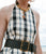 Model in plaid dress wears Geo Chain Belt in Black and assorted necklaces.