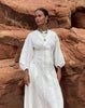 Video clip of model against desert rocks in white dress, Sky Stone Necklace, Desert Daisy Necklace and Sky City Earrings.