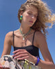 Video of model in swimwear with Atlantic Necklace in Grass, King Tide Necklace, Peniche Heart Earrings and Ridge Cuff.